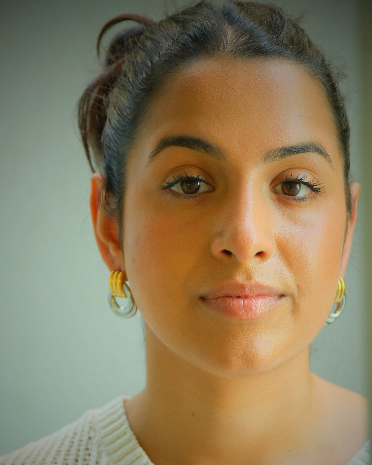 model wears mixed metal elvira hoops earrings