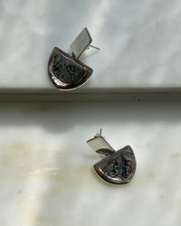 Silver rectangle said top earrings with a half circle of abalone hanging off sit on a marble base from Surry Hills Studio The Pared Store