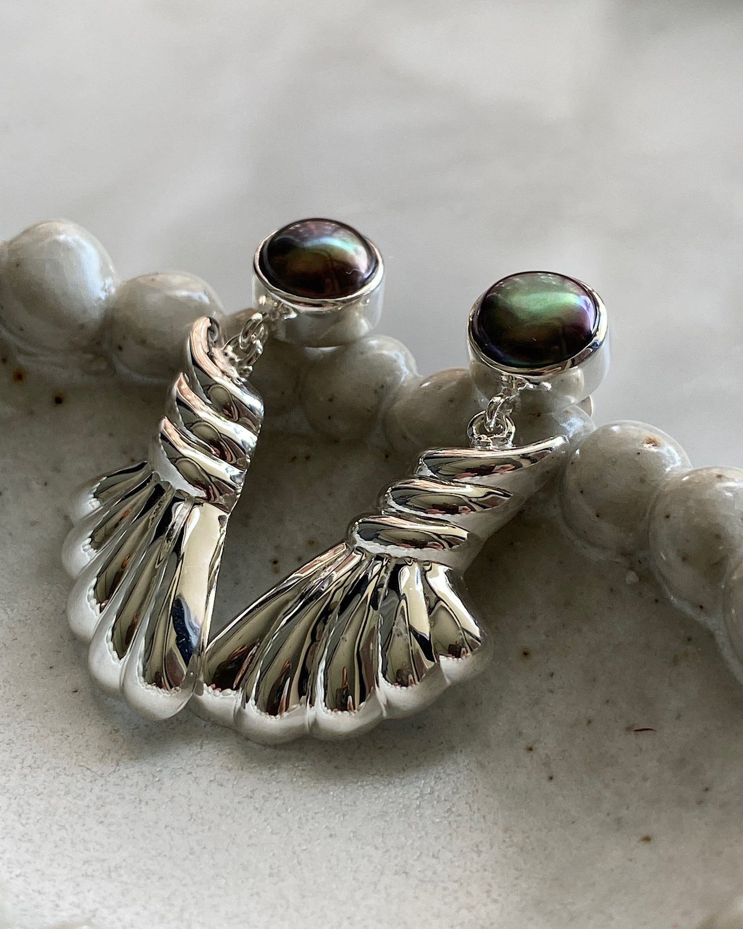 black pearl stud earrings with a silver drop