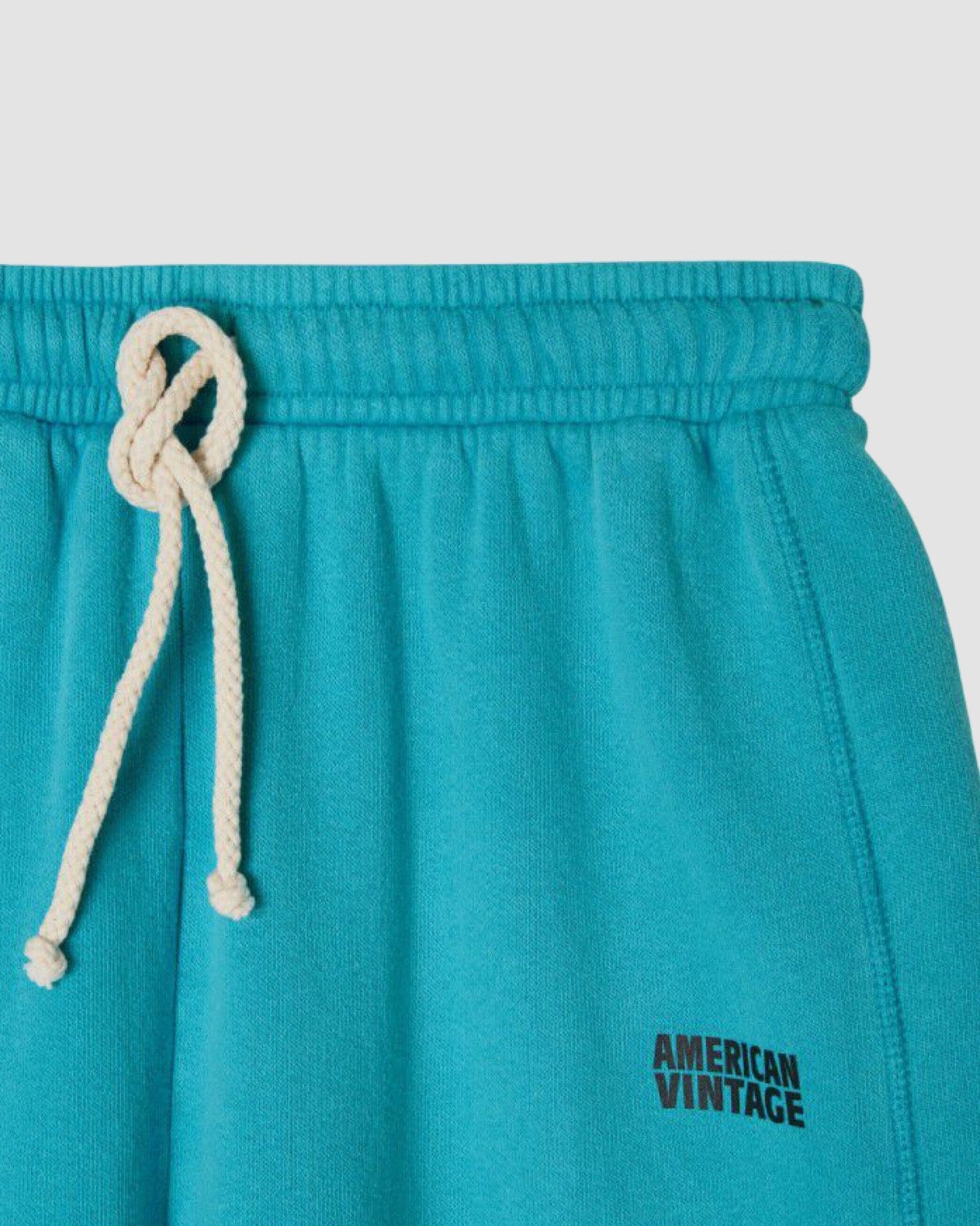 turquoise sweatpants with white drawstrings