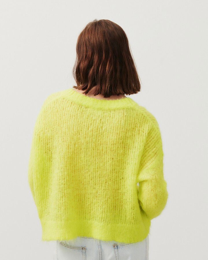 back view of an open weave neon yellow sweater