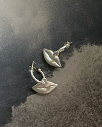 Silver lips charms on a huggie earring