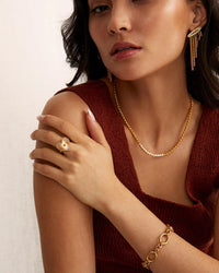Model wears gold earrings by Soru Uk and Other Gold jewellery