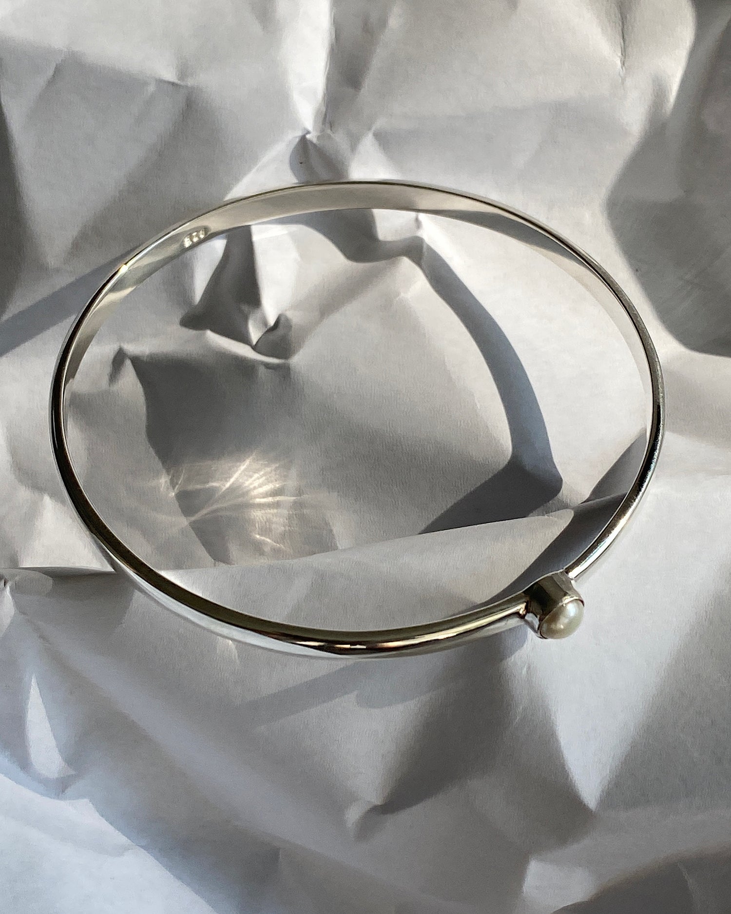 simple thin silver bangle with a single pearl inlaid half way around it | peaRL THIN BANGLES SURRY HILLS, SYDNEY