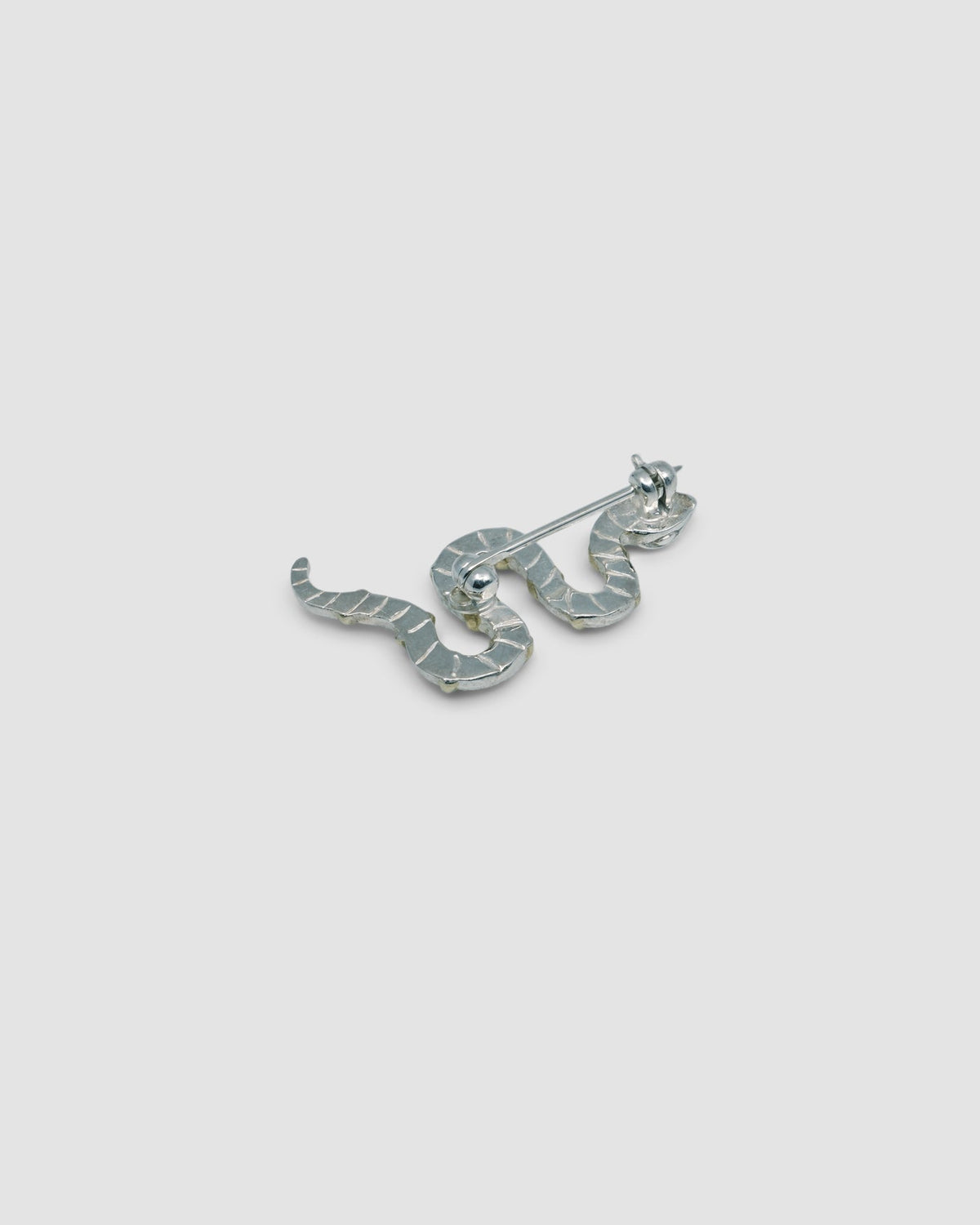 the back of a snake brooch - silver stripe detail and clasp