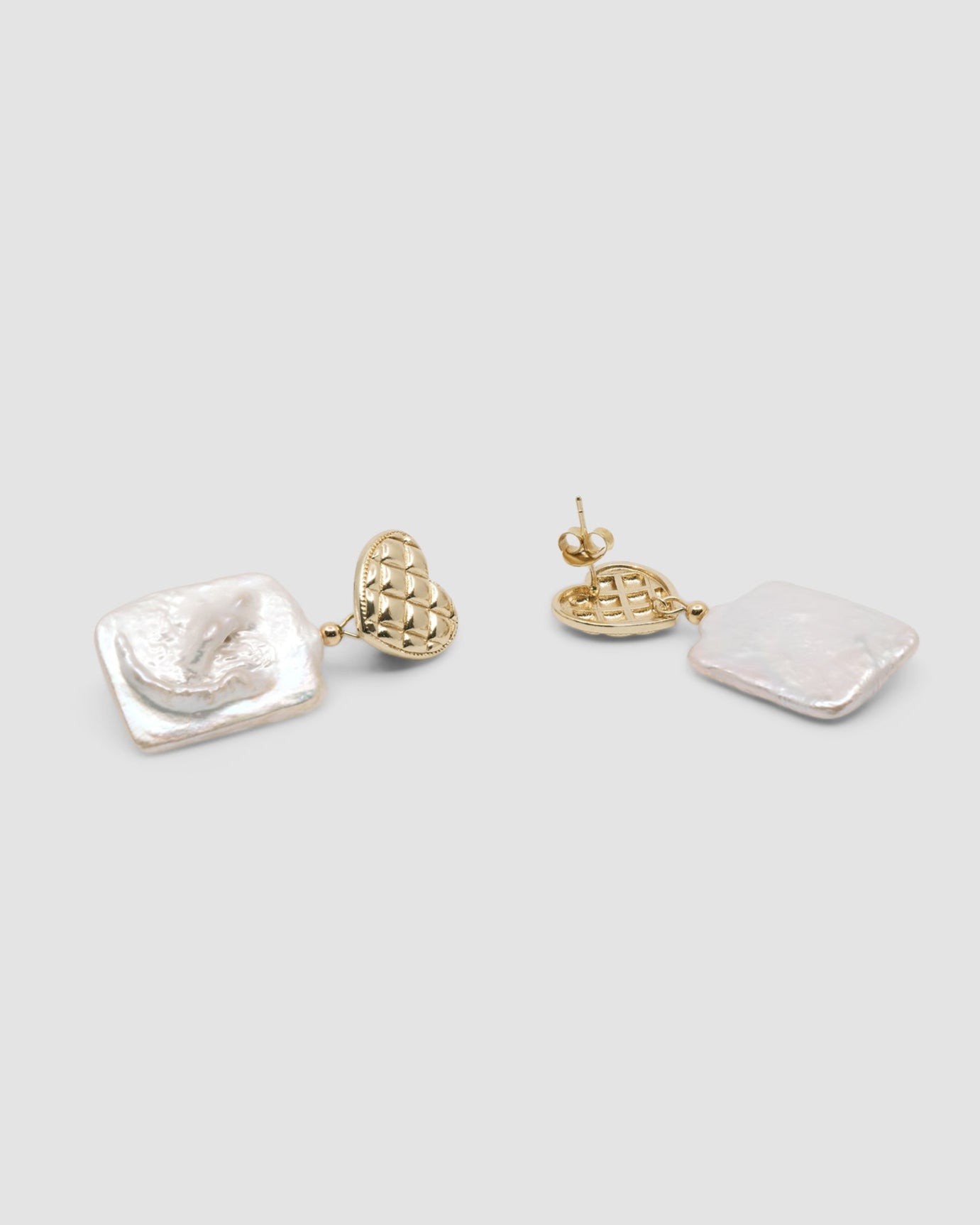 gold quilted studs with rectangular pearls hanging from them