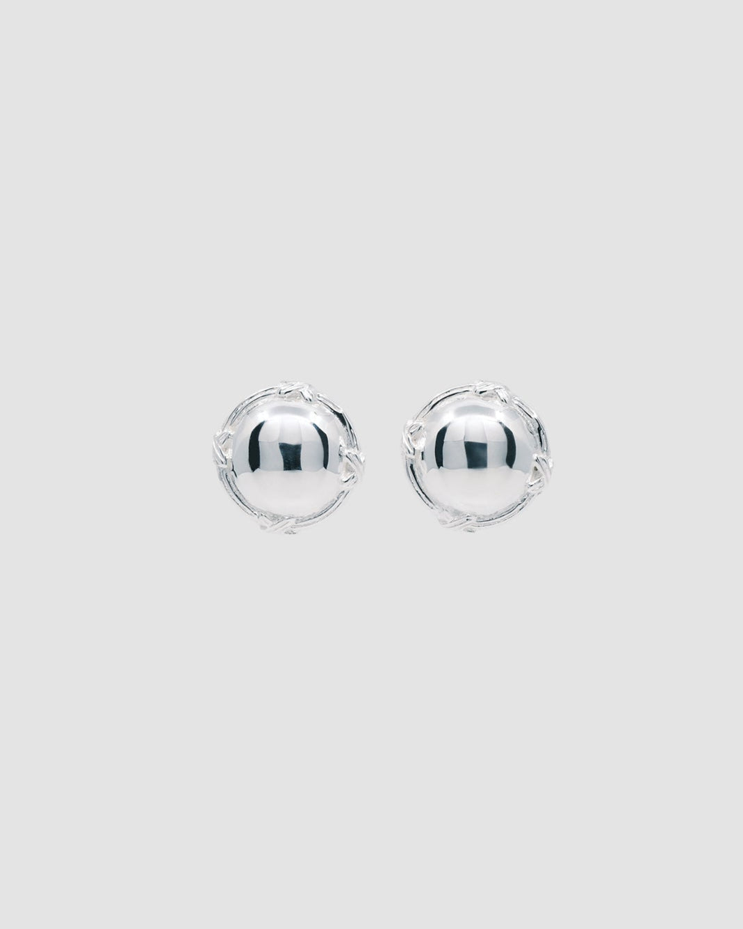 silver round earrings with a border with crosses