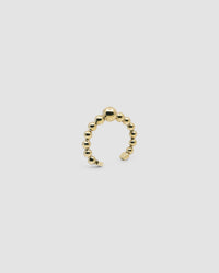 an open gold cuff bangle consisting of numerous interlinked gold balls