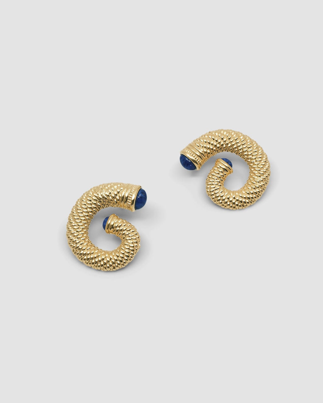 large round swirl textured gold earrings with blue stone ends