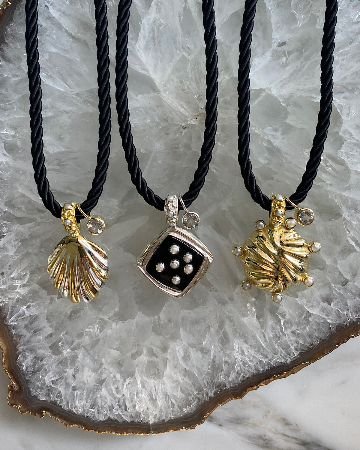 a set of 3 cord style necklaces with various pendants