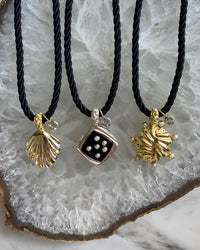 a set of 3 cord style necklaces with various pendants