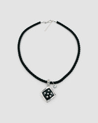 Inlaid black pendant studded with pearls sits on a black cord chain