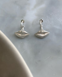 Silver lips charms on a huggie earring