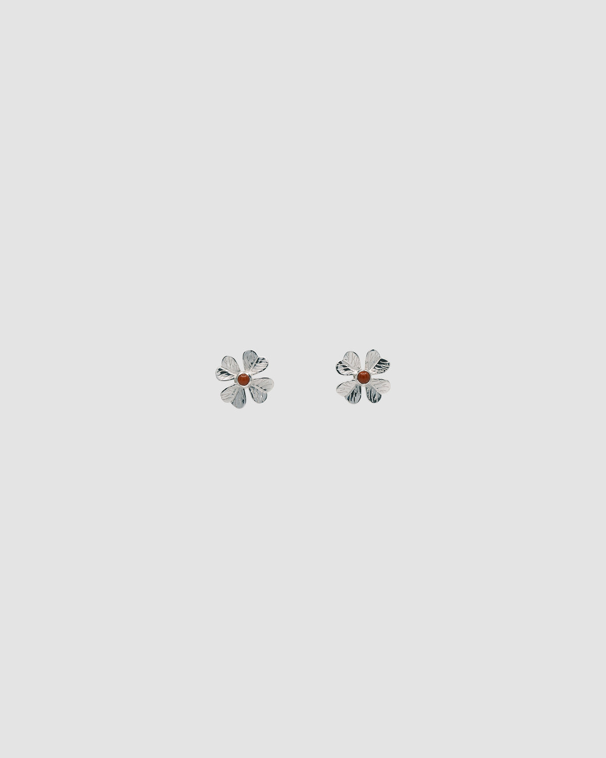 single four leaf clover stud with a central coral stone