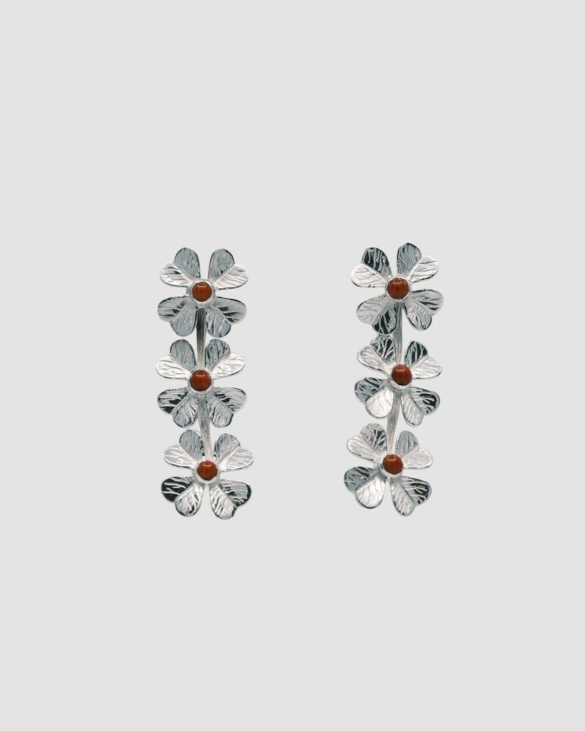 triple four leaf clover silver drop earrings featuring coral