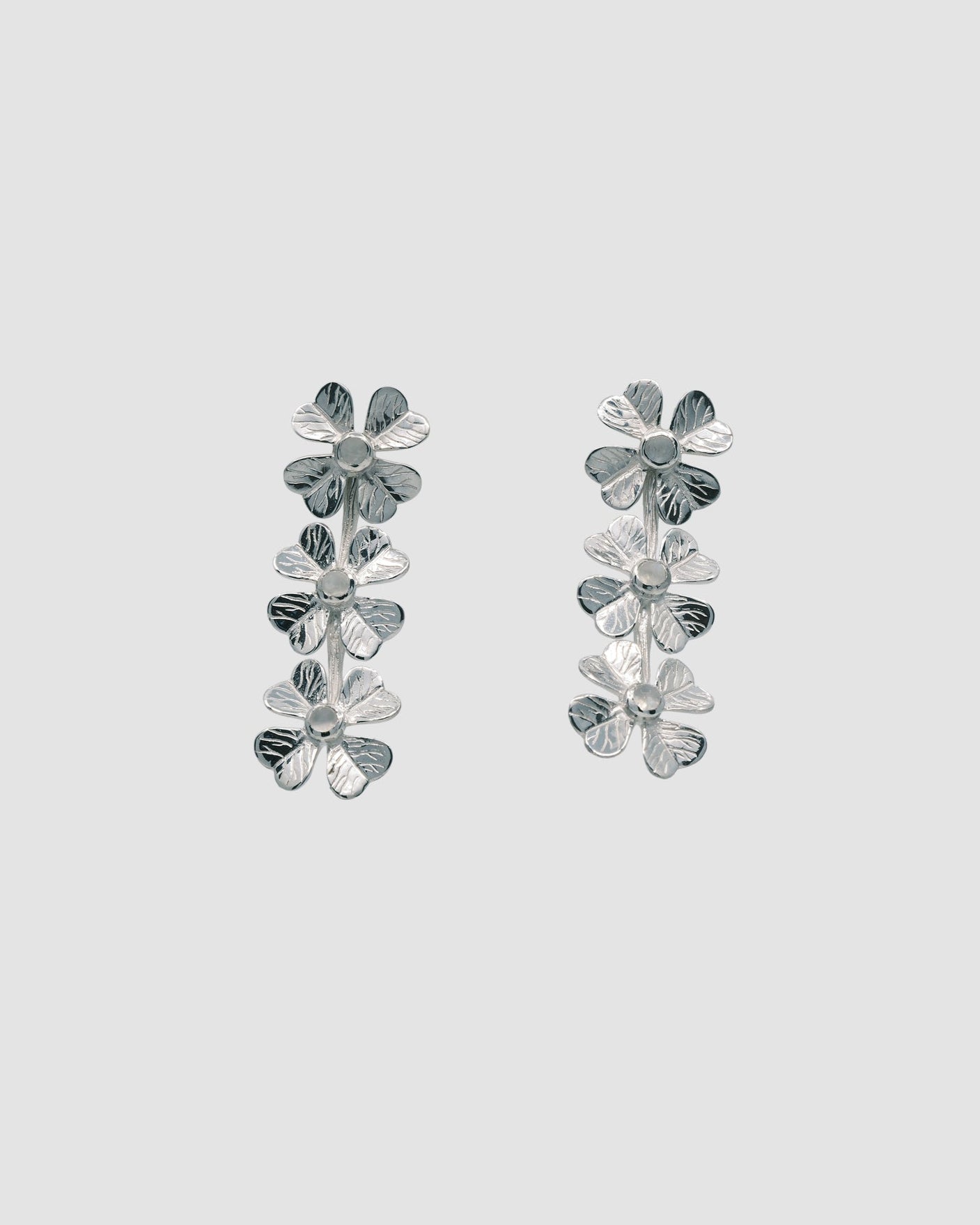 drop silver earrings featuring four leaf clover with a moonstone centre