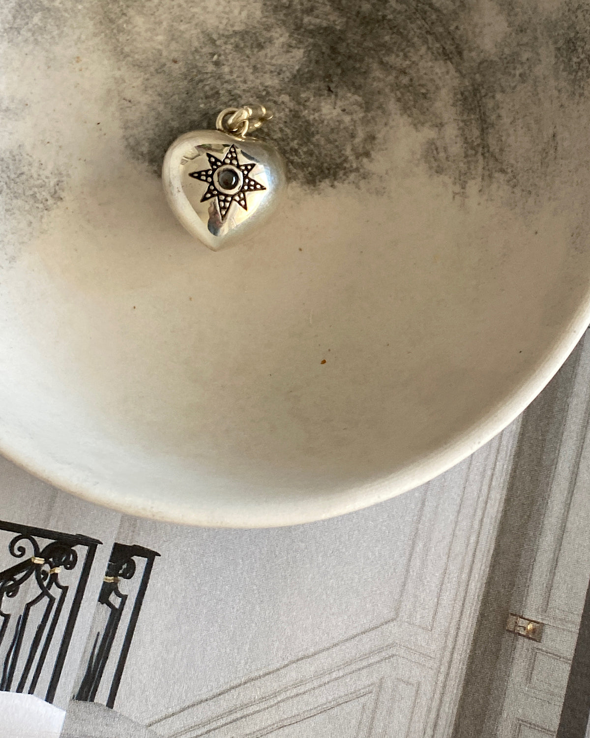 a small chubby heart charm with an inlaid star
