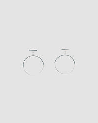 silver circle earrings hang from a bar stud