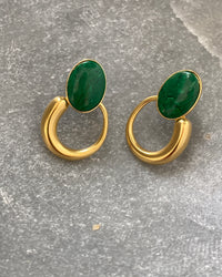 Green stone studs earrings with gold irregular hoops hanging off the bottom in a stone  bowl