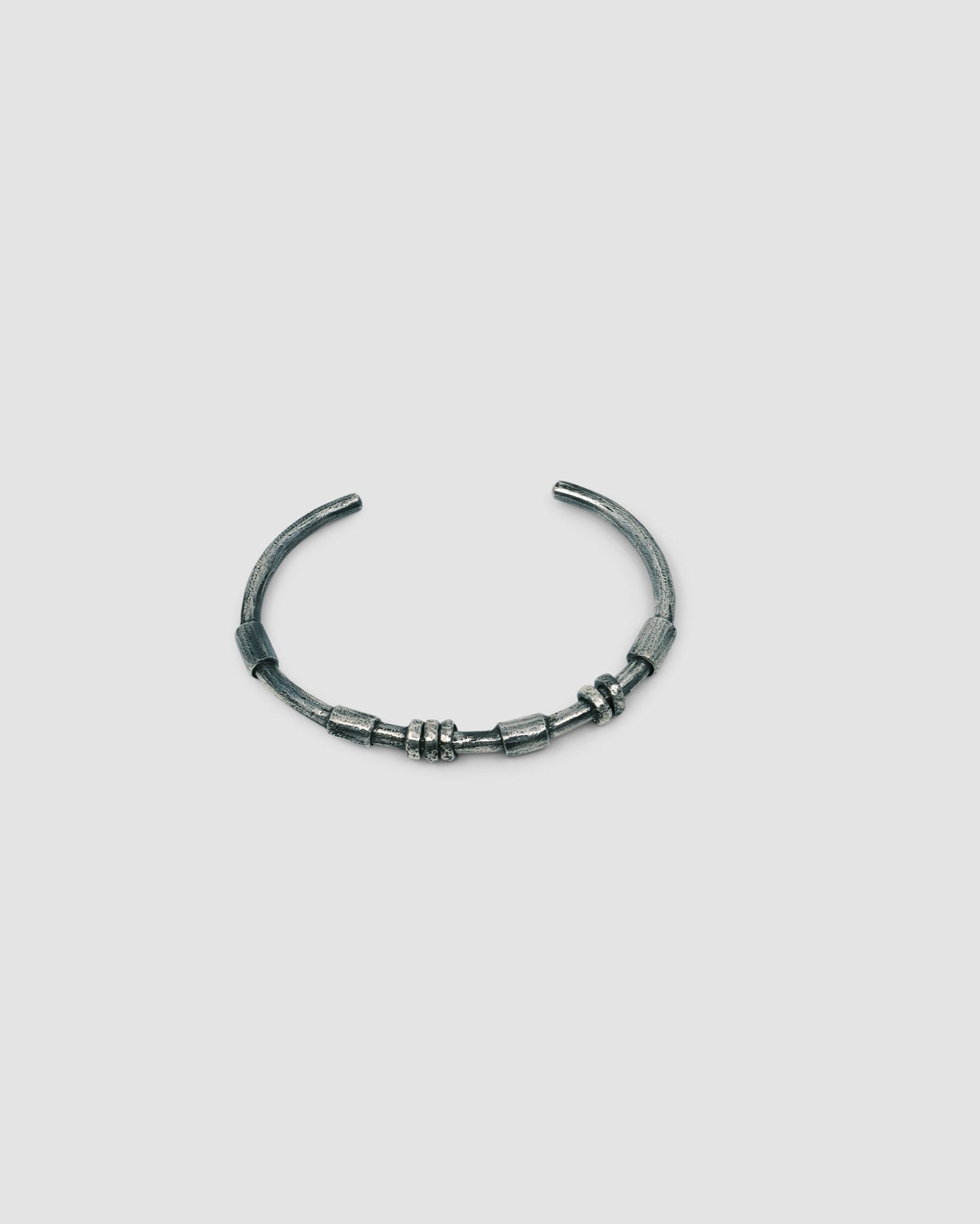 dark blackened silver thin cuff bangle with oval tube silver bead detail