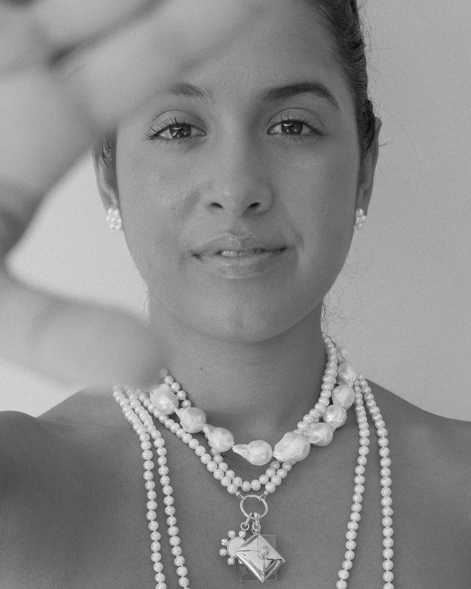 small pearl flower stud earrings and pearl necklaces on a model