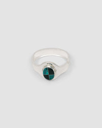 silver cuff bracelet with an inlaid black and green stone