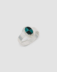 silver cuff bracelet with an inlaid black and green stone