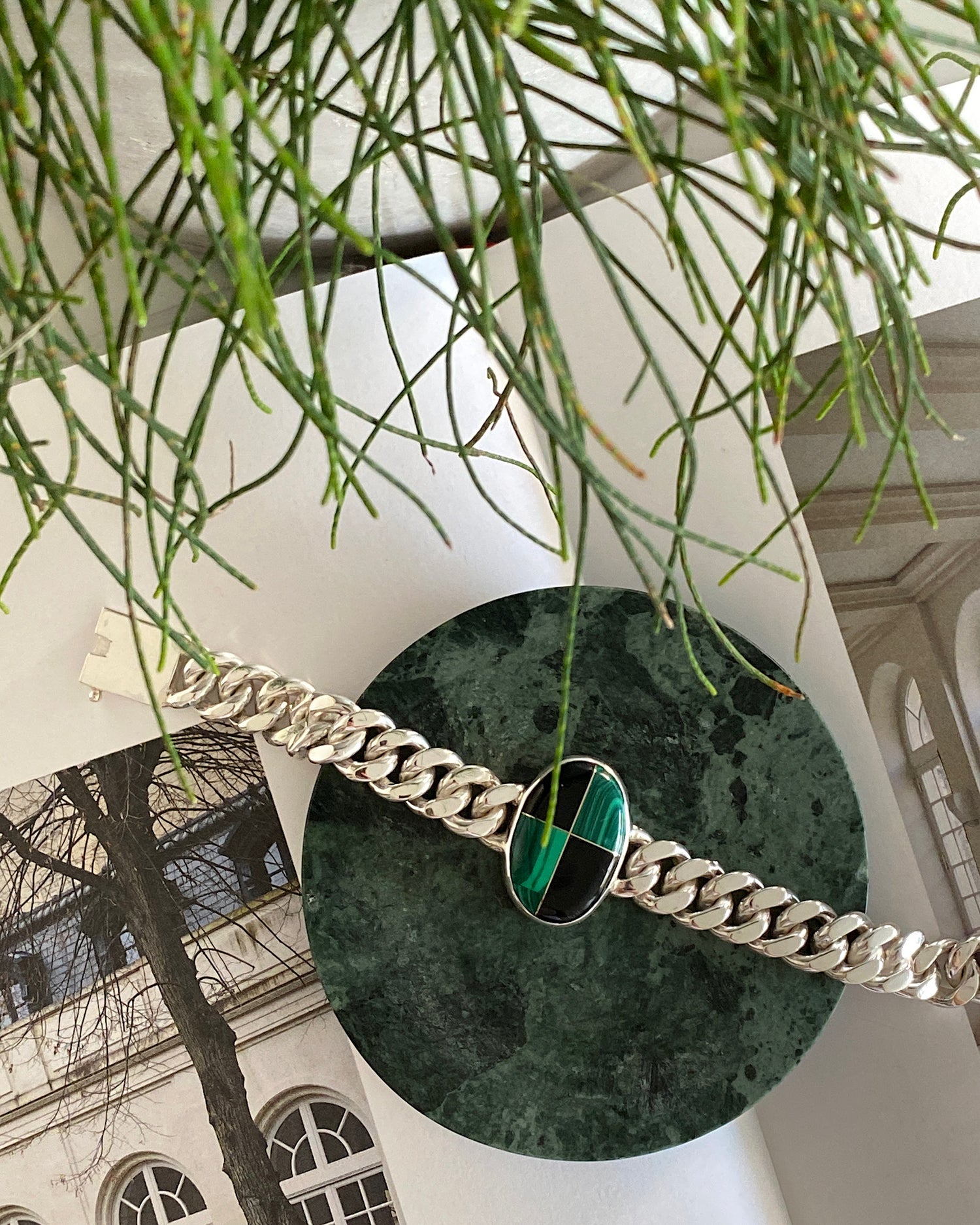 Silver cuban link chain with a chequerboard style inlaid stone which is green & black