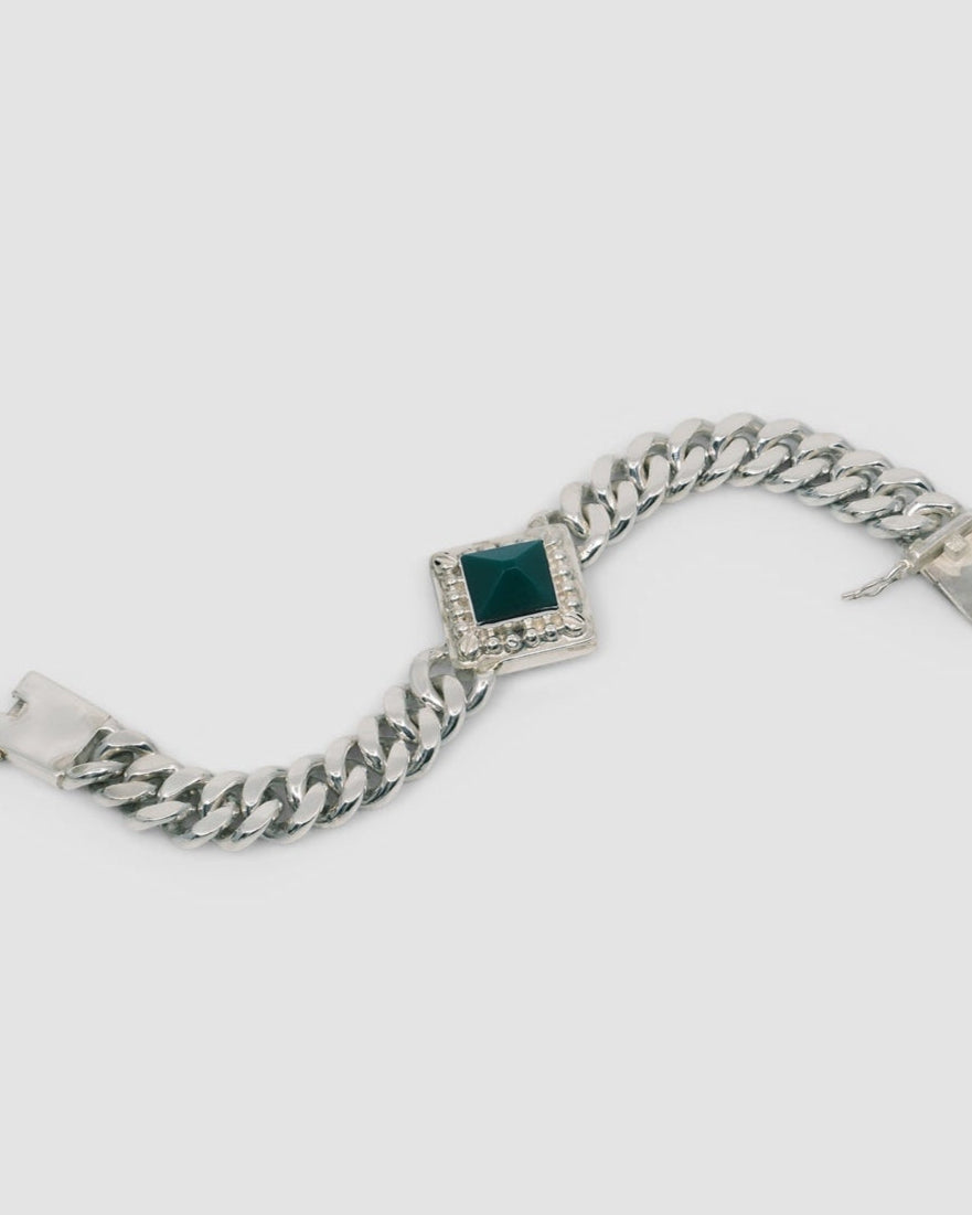 silver cuban chain link necklace with a square pendant set with a green pyramid stone
