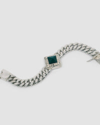 silver cuban chain link necklace with a square pendant set with a green pyramid stone