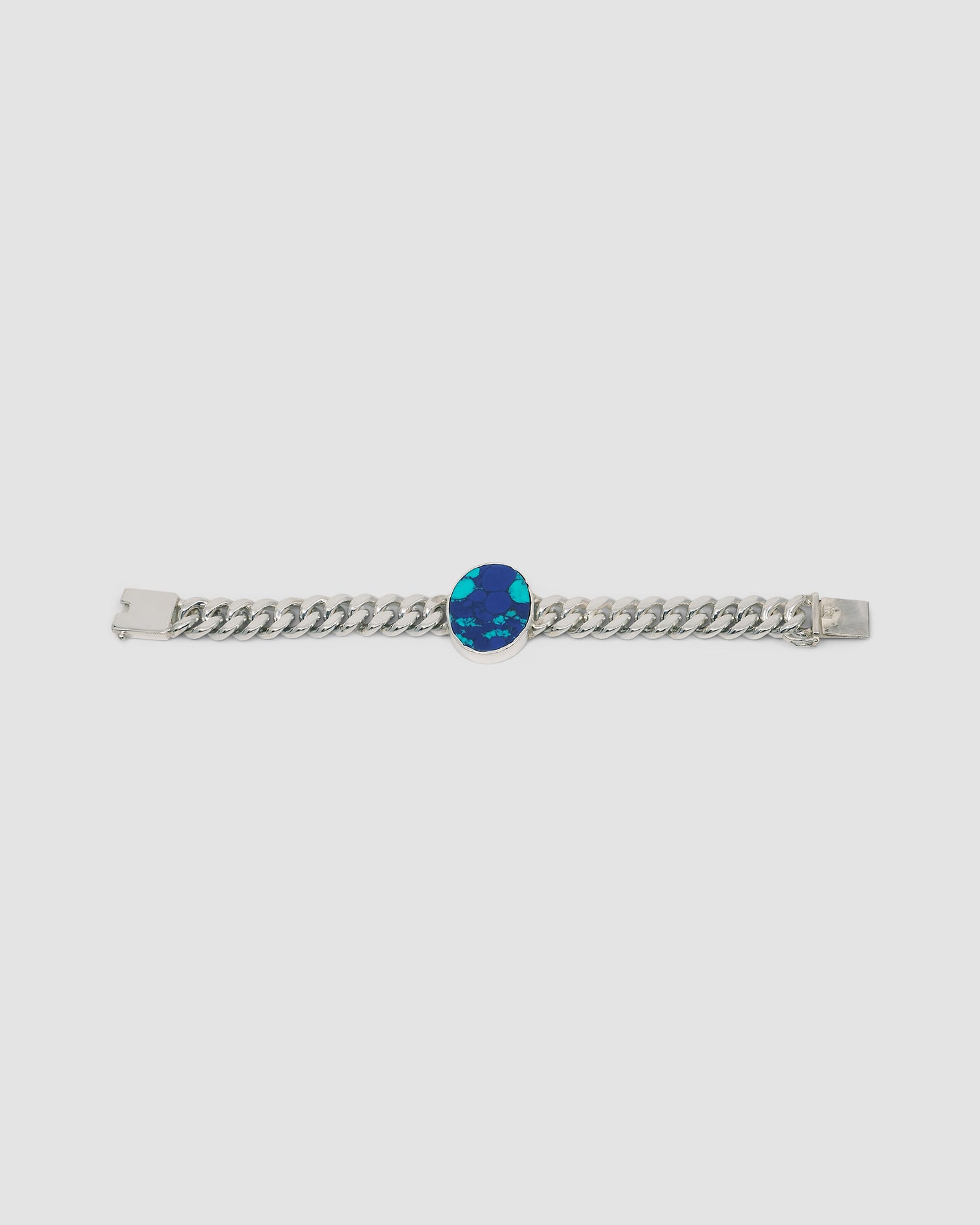 a silver link chain bracalet with a large blue green stone set in the middle