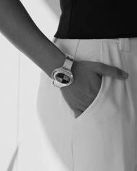 model wears a checkerboard sttle stone inlaid cuff