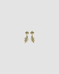 Gold sculptural drop earrings against a grey background