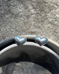 silver heart earrings sit in bowls
