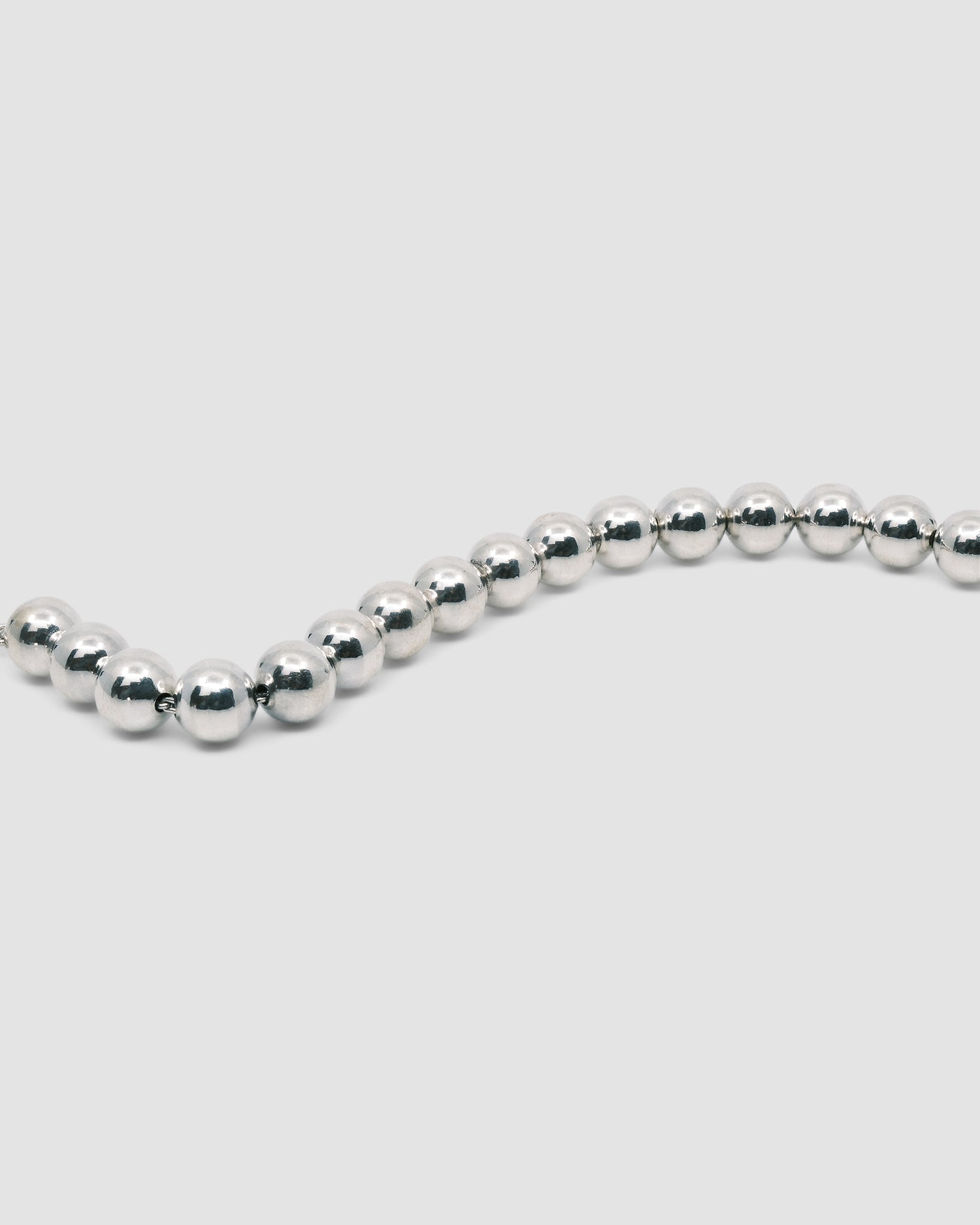 a bracelet consisting of silver balls on a chain