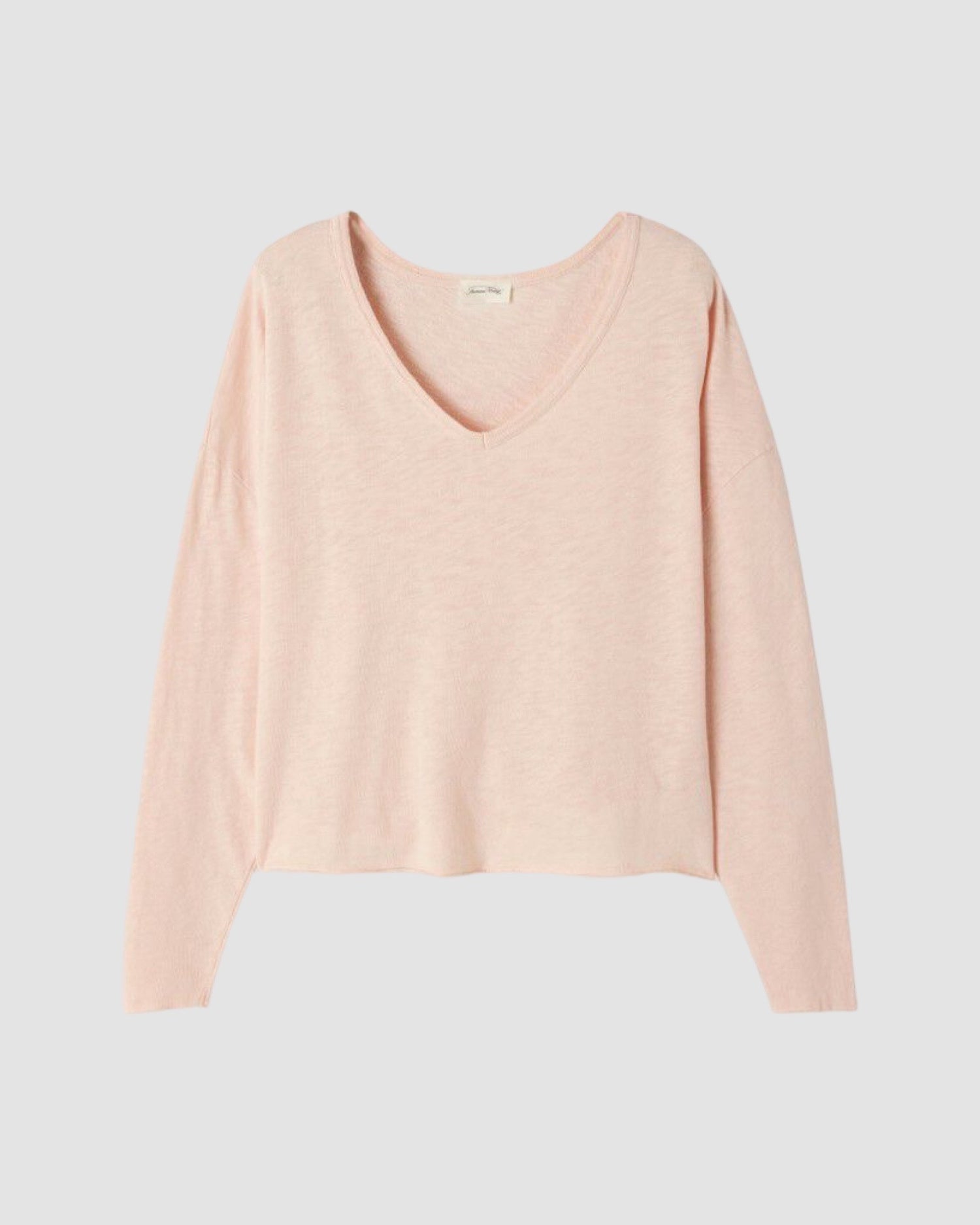Nude Pink v neck long sleeve tshirt on a light gray background