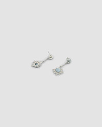 silver star drop earrings pictured front and back sit on a grey background