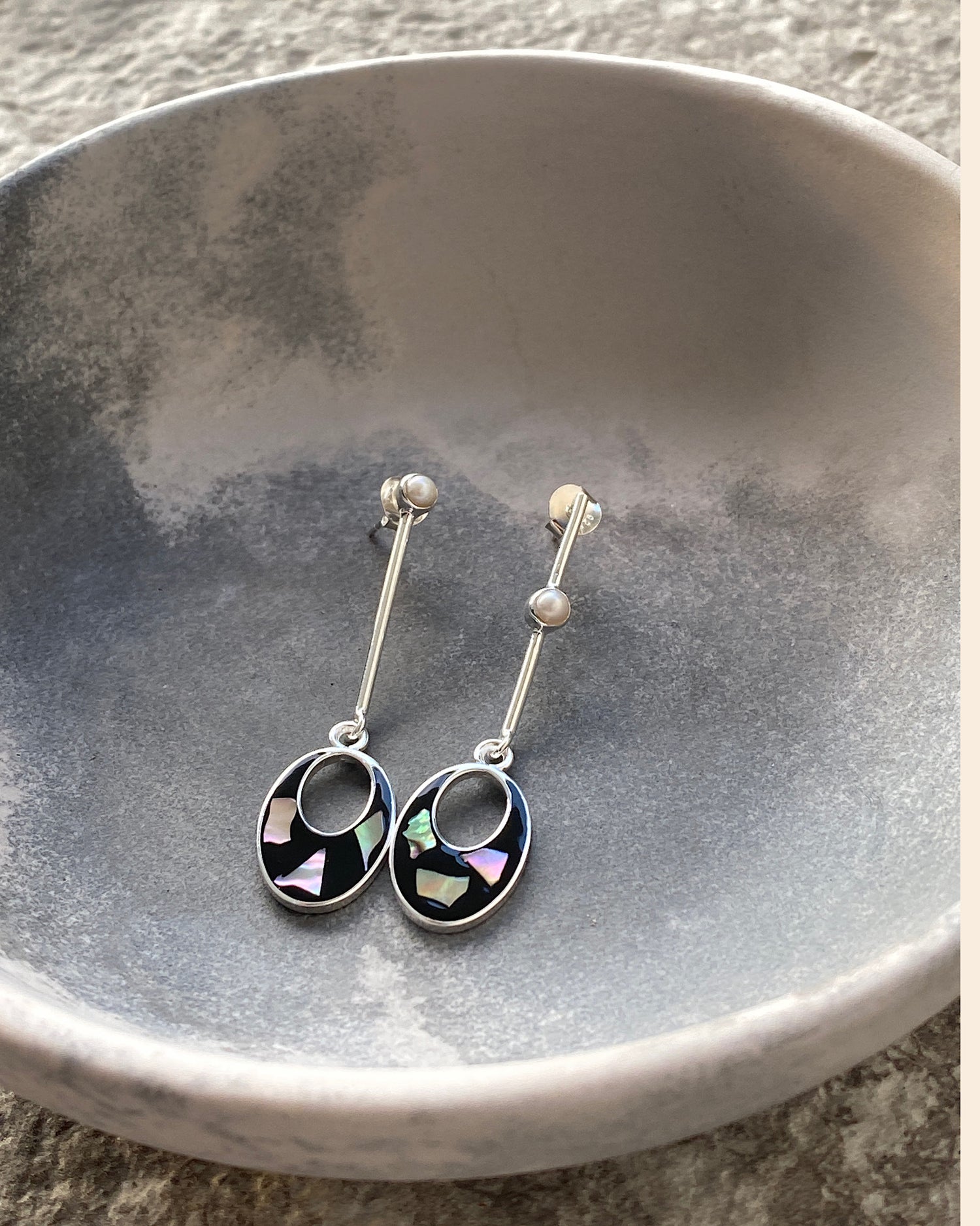 silver drop earrings with black and shell drop charms and odd pearls on the drop