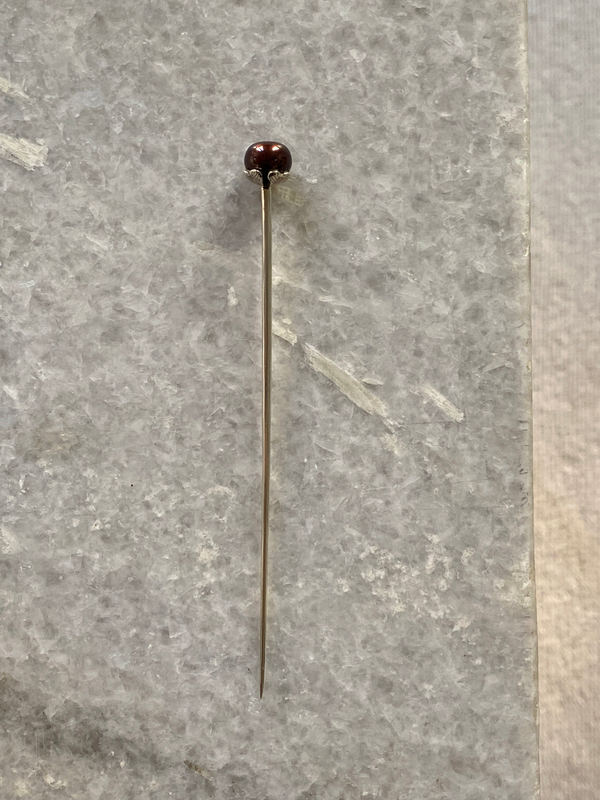 a martini pick with a black pearl