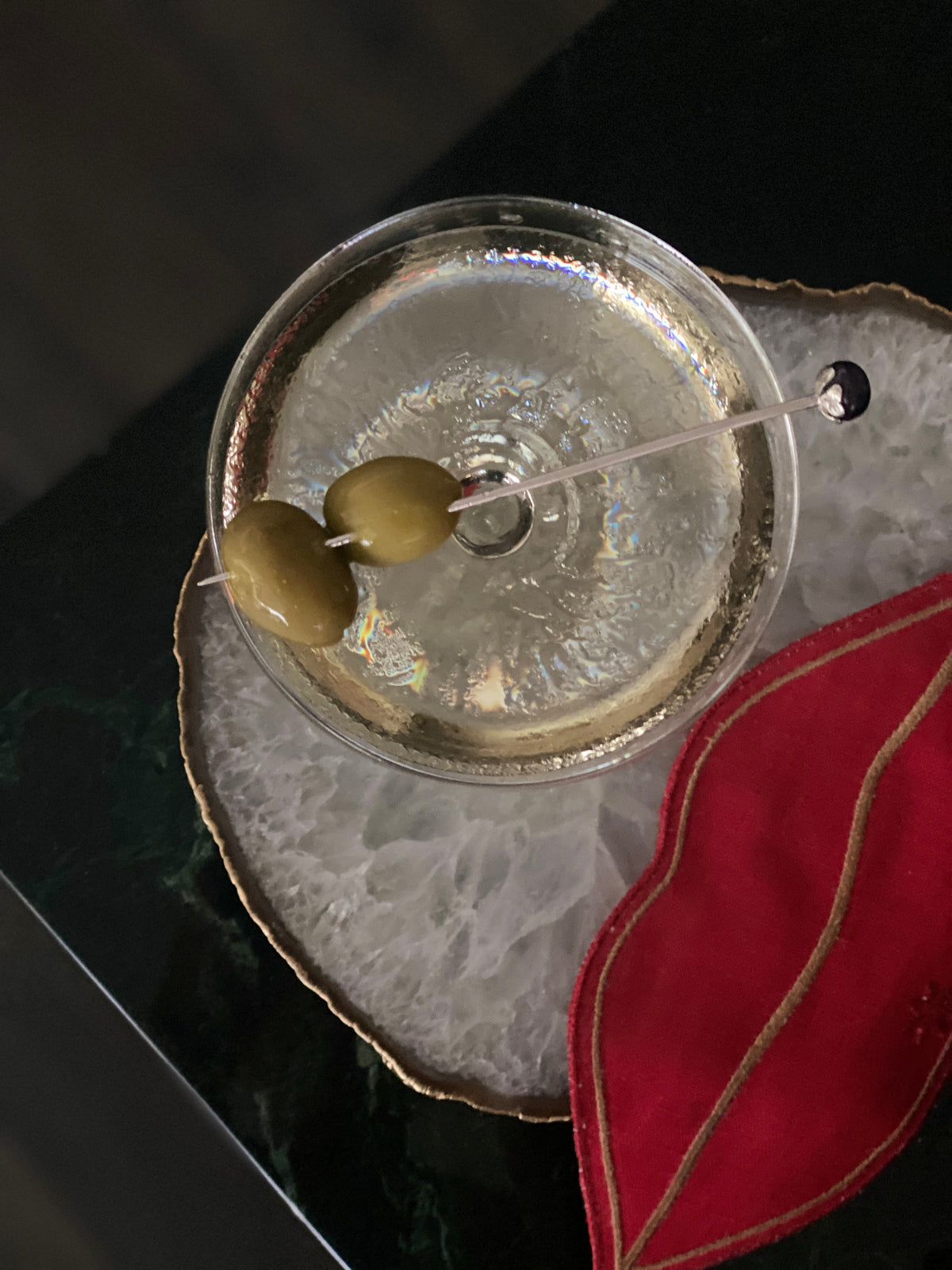 a martini pick with a black pearl