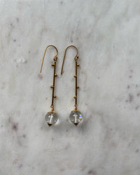 Long gold drop earrings with clear quartz