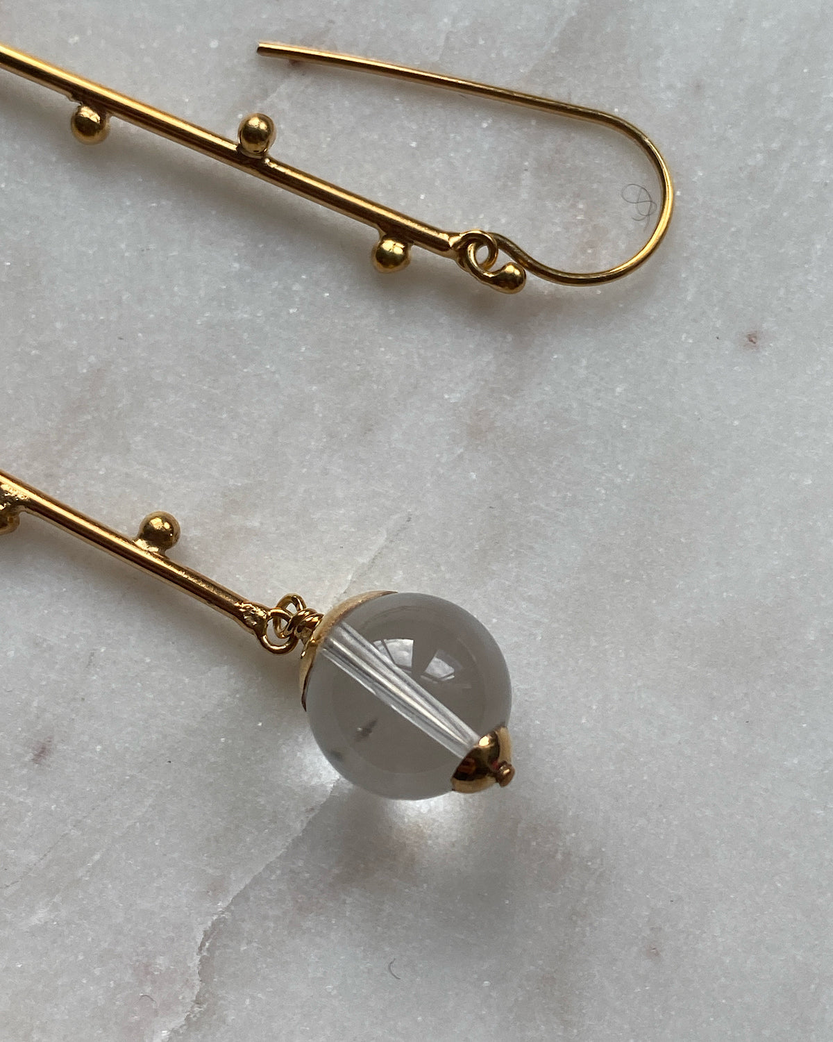 Long gold drop earrings with clear quartz