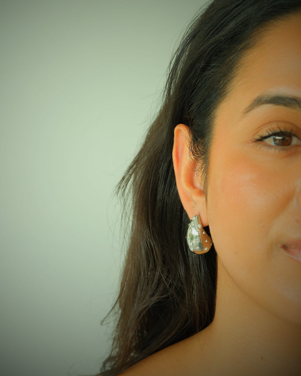 model wears crystal sloane earrings in silver