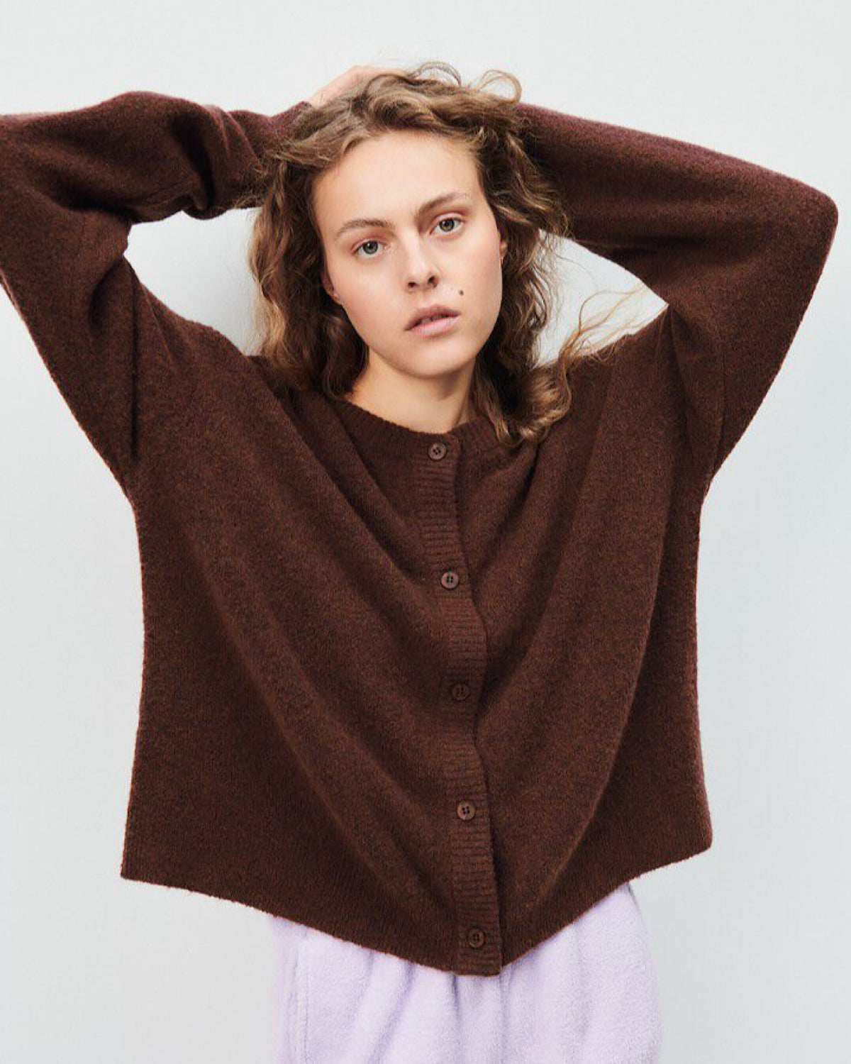 Simple round neck button through Cardigan in Brown by American Vintage at The Pared Store worn by a model