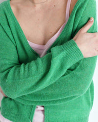 American Vintage Green cardigan worn by a person on a white background