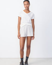 Model wears a white gamipy V neck Tshirt by American Vintage at The Pared Store