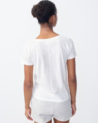 Model wears a white gamipy V neck Tshirt by American Vintage at The Pared Store