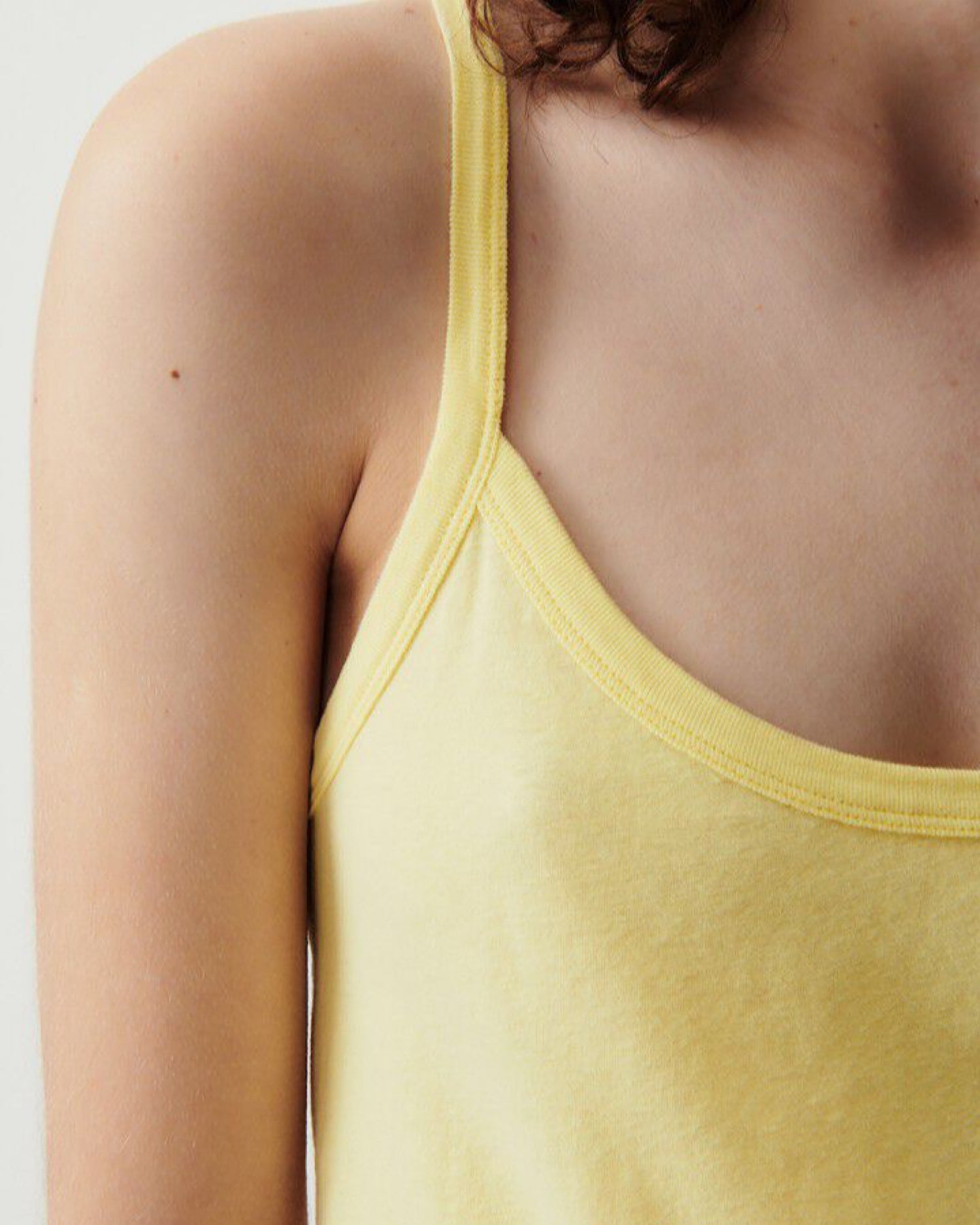 Model wears a pale yellow gamipy tank top