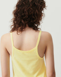 Model wears a pale yellow gamipy tank top