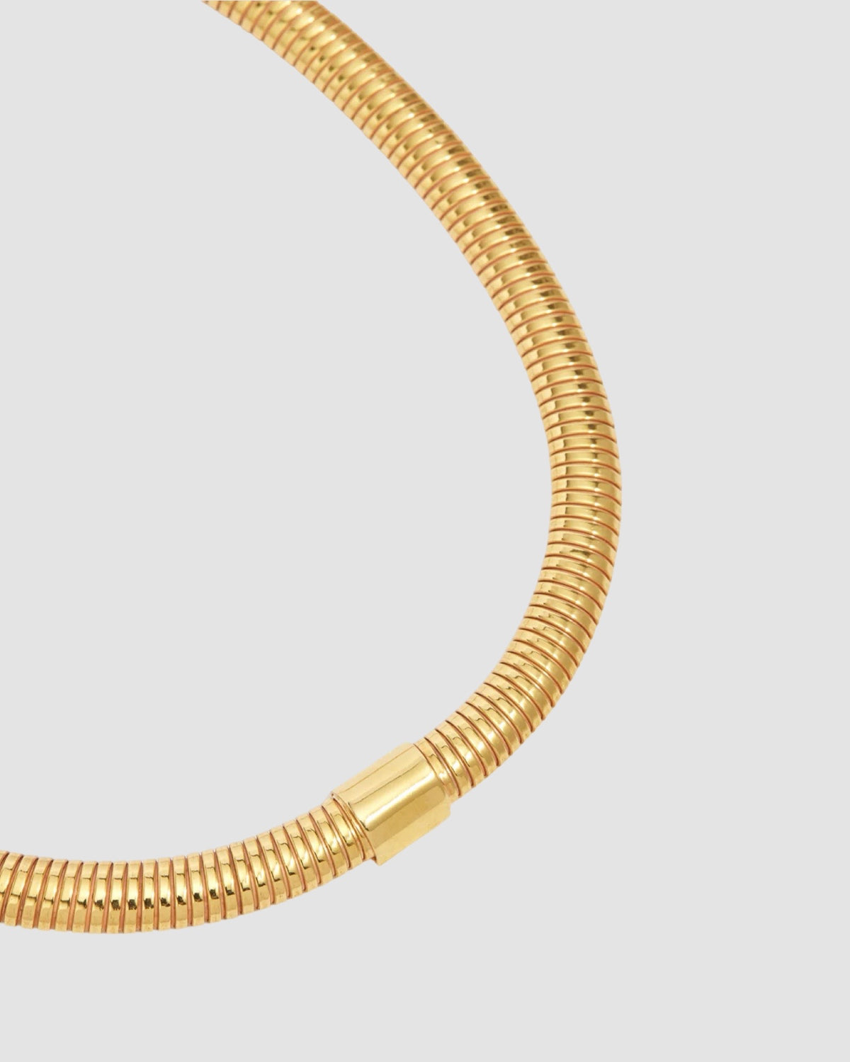 a closeup of a gold snake chain